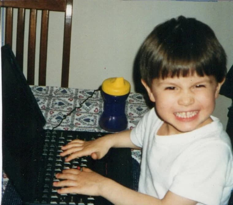 Kyle as a kid, already at a laptop